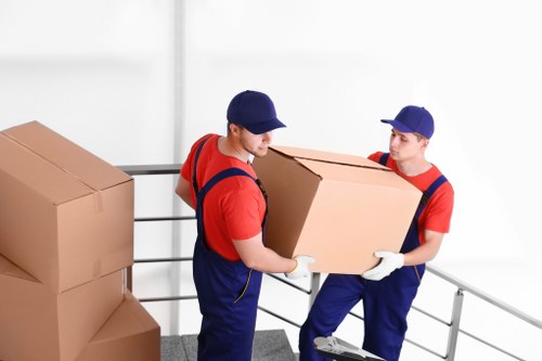 Removal team preparing flat removals in Brockley with boxes and furniture