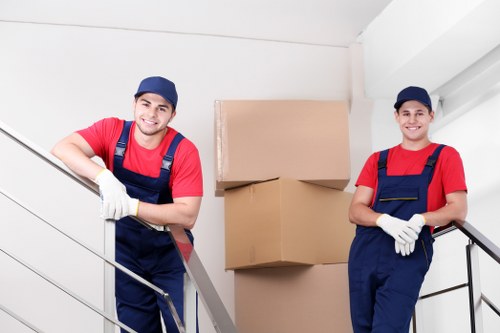 Moving crew handling furniture and boxes for a local commercial relocation