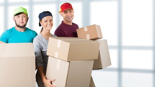 Staff carrying furniture with protective moving equipment