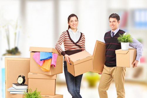 Team member using safe lifting practices during a house move